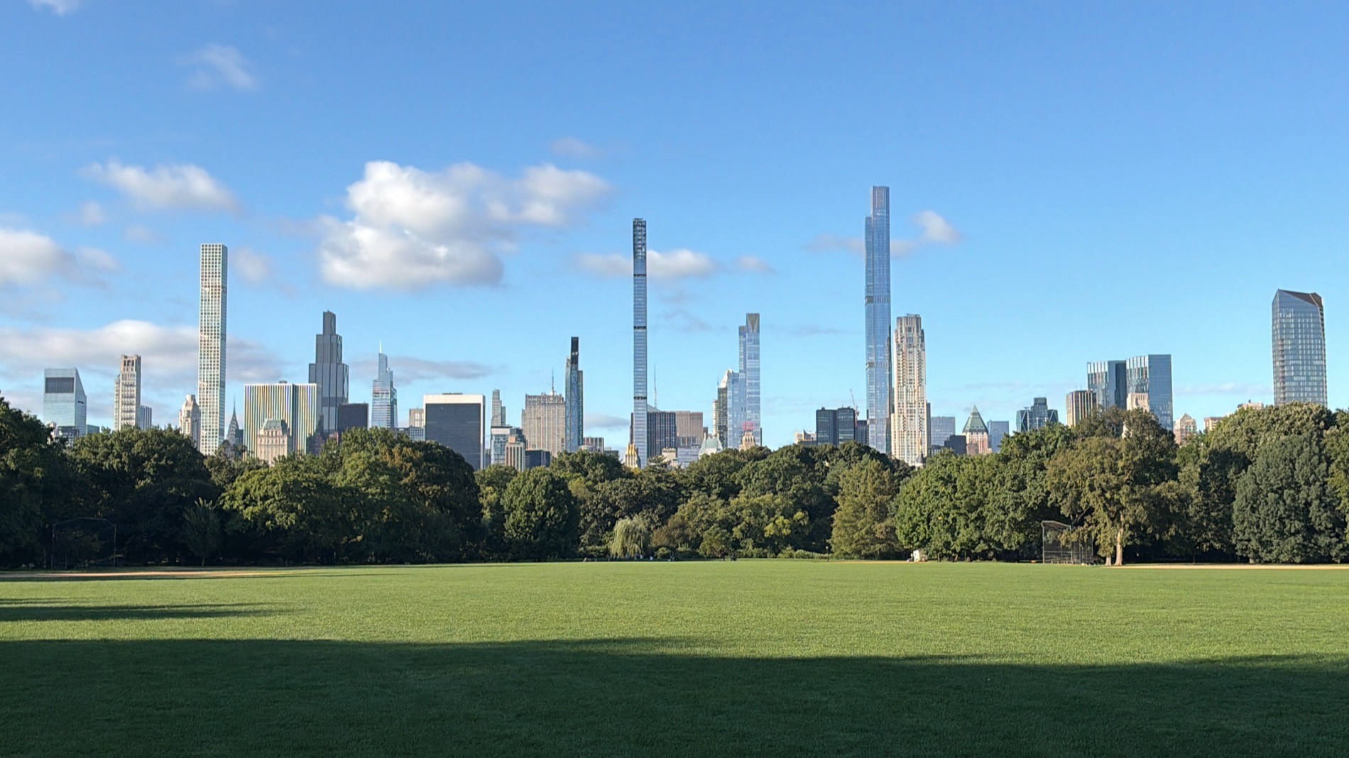 The Sheep Meadow in Central Park with the Manhattan skyline behind it